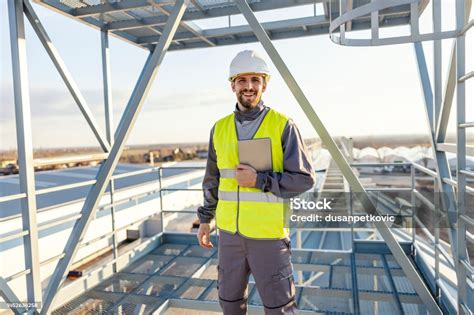 heavy industry worker standing  silo  tablet   hands