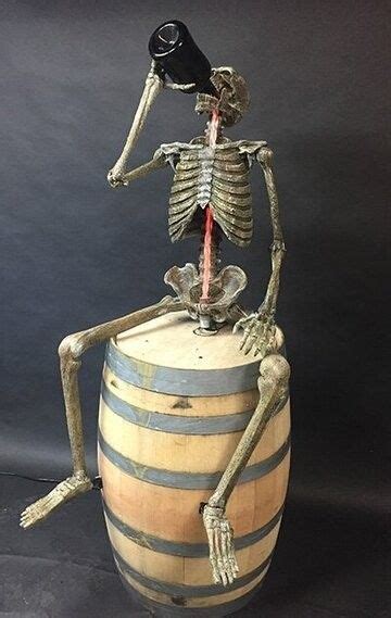 A Skeleton Sitting On Top Of A Barrel