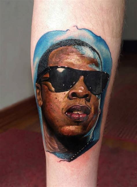 Realistic Jay Z portrait tattoo on the left forearm.