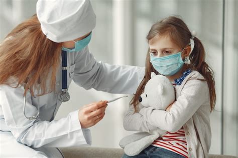 Free Photo | Doctor and a child in protective masks are in hospital