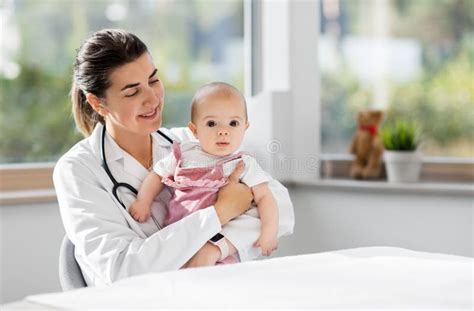 Female Pediatrician Doctor With Baby At Clinic Stock Image Image Of