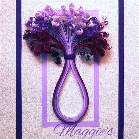 A Purple Hair Clip With Flowers On It And The Words Magnes Written In Blue