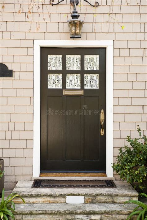 Wooden Front Door of White Brick Home with Plants Stock Photo - Image ...