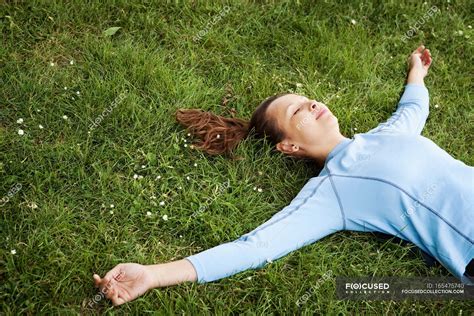 Woman laying in grass at park — daytime, tranquil - Stock Photo ...