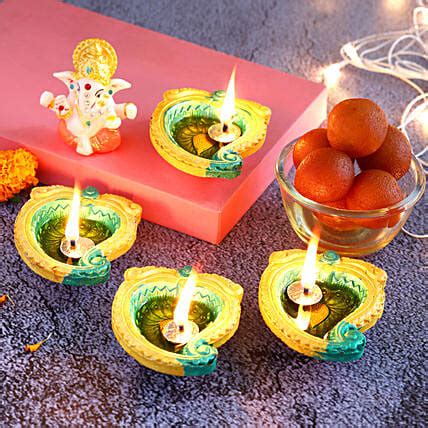 Buy Send Designer Diyas Ganesha Idol With Gulab Jamun Online Fnp