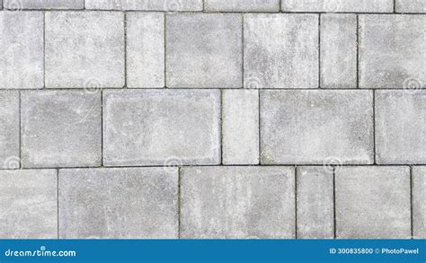 Close Up Of Pebbly Gray Cement Bricks Paving A Textured Road Stock