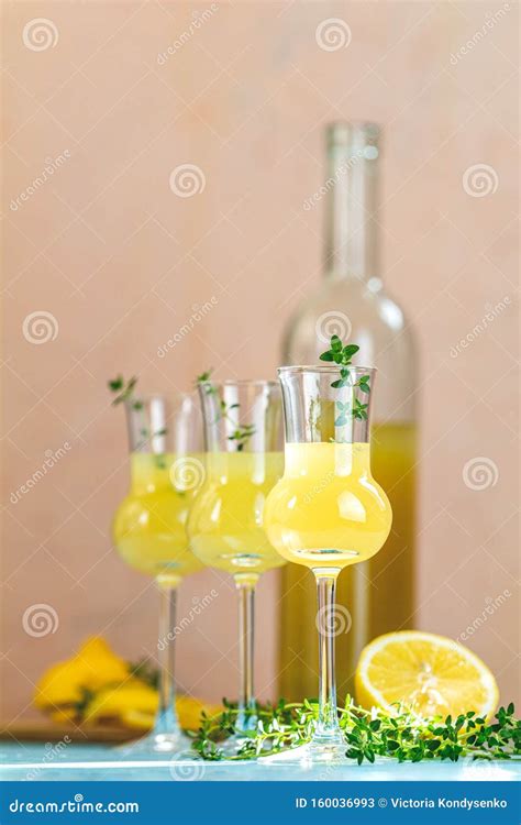 Limoncello With Thyme In Grappas Wineglass With Water Drops On Light