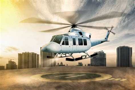 White Helicopter Landing On Helipad At Building Rooftop Stock Image