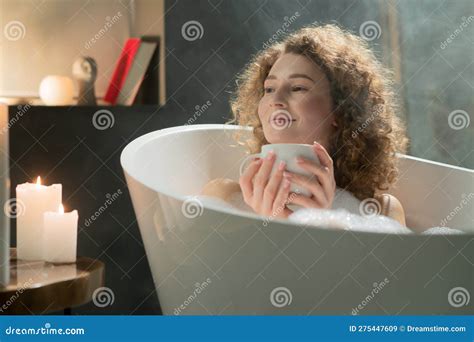 An Attractive Lady With A Cup Of Tea In Her Hands Is Basking In A Warm Foamy Bath A Beautiful