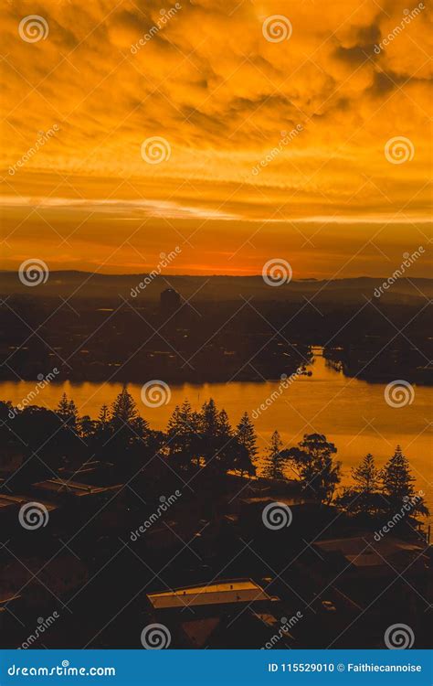 Dramatic Orange Sunset Over The Coastline And Buildings Of Surfers