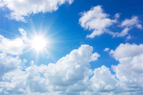 Bright Sun Shining Through Clouds In Blue Sky