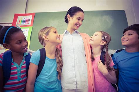 Teacher And Pupils Smiling In Classroom School Early Learning Classroom ...