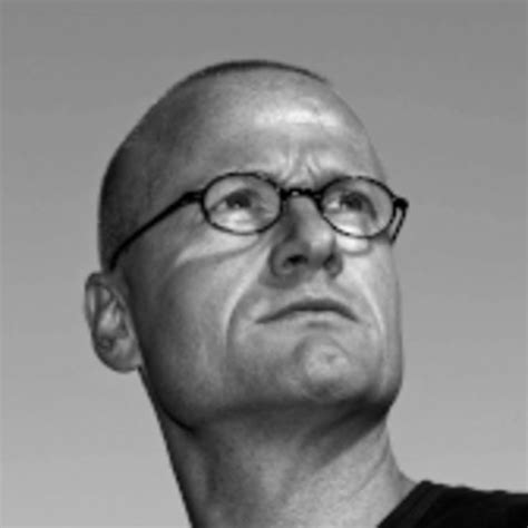 Black And White Photo Of Man With Glasses Looking Off To The Side In