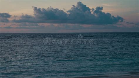 Beautiful Twilight Landscape With Calm Surface Blue Ocean Under Pink