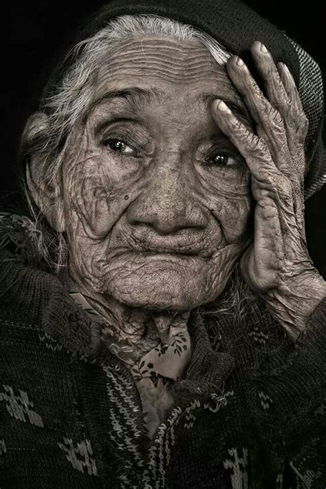 An Old Woman With Wrinkles Holding Her Head