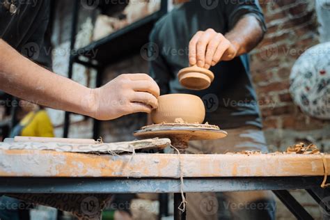 Making a handmade clay pot in the workshop. Pottery lesson, hobby ...