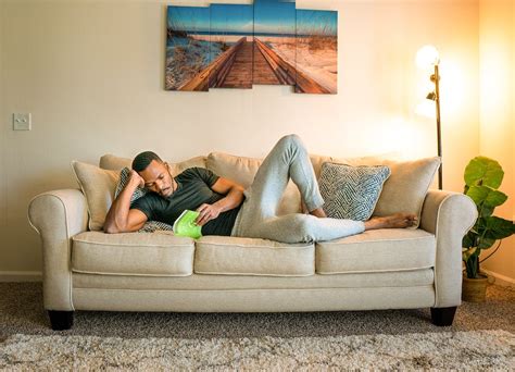 Man lying on Couch while Reading a Book · Free Stock Photo