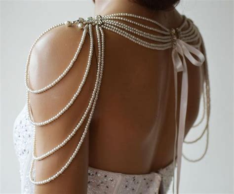 The Back Of A Womans Dress With Pearls On It