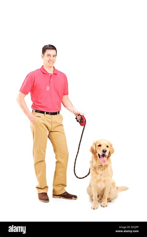 Young Man Holding A Dog On A Leash Isolated On White Background Stock