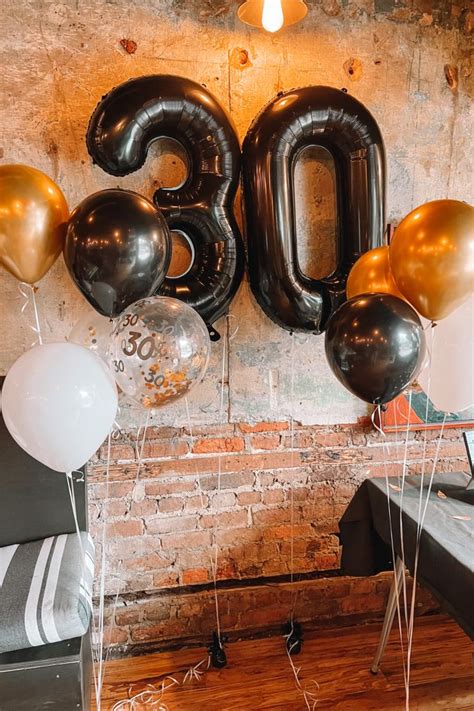 balloons and streamers in the shape of the number 30 are on display at ...