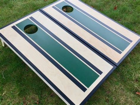 A Close Up Of A Cornhole Board On The Grass