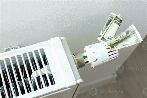 heating thermostat with money, dollar, expensive heating costs concept ...