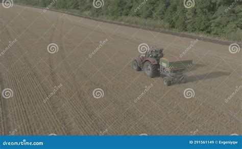 Farmer On Tractor Fertilizing Agricultural Field Spreading Mineral