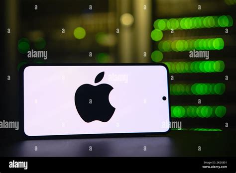 Apple iphone company logo on the background of a bokeh server light ...