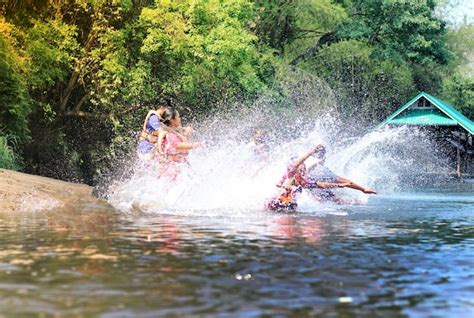 Premium Photo | People splashing water in river