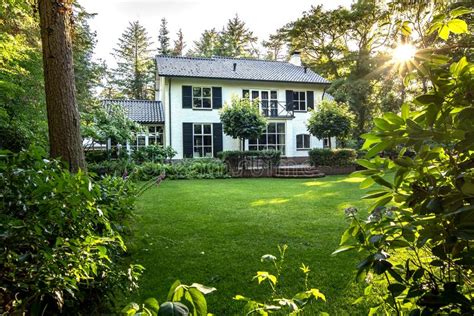 Beautiful White House with a Green Garden Surrounded by a Lot of Green ...