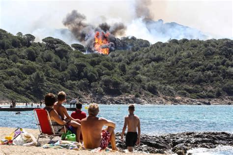 Sunbathers Watch From Beach As Wildfires Burn In French Riviera