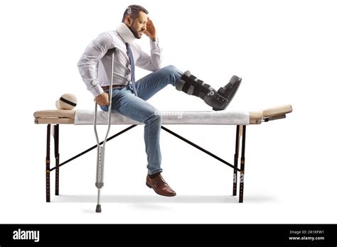 Injured Man With An Orthopedic Boot And Cervical Collar Sitting On A