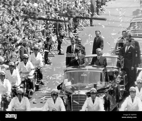 The American president John F. Kennedy (standing in the car and waving, left) on a four-day trip ...