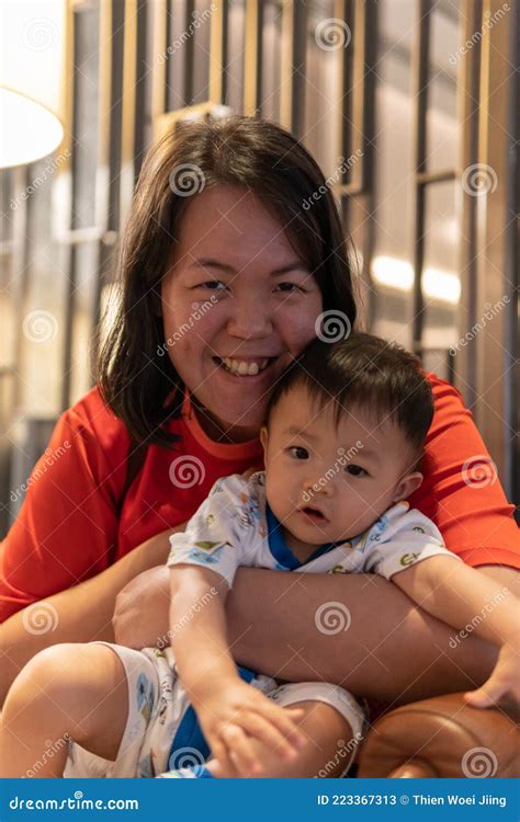 Portrait Image Of Cute And Adorable Asian Chinese Baby Boy Carry Up By