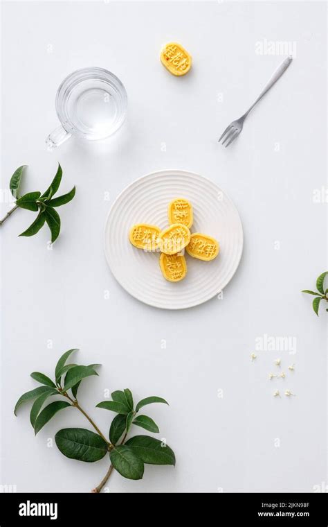 A vertical shot of aesthetic table setup with traditional Chinese osmanthus cake Stock Photo - Alamy