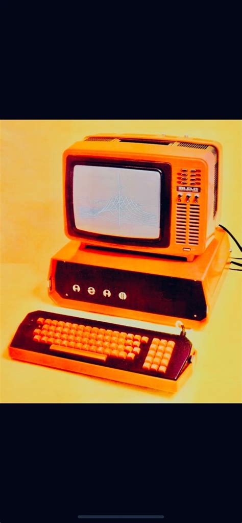 An Old Fashioned Computer With A Keyboard And Mouse In Front Of It On A