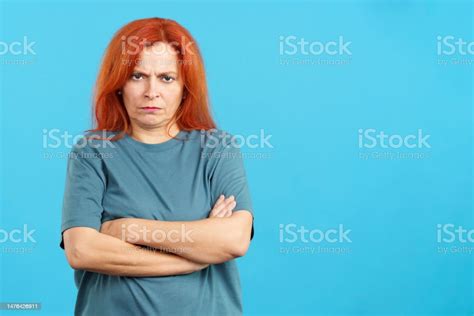 Mature Redheaded Woman Crossing The Arms With An Angry Expression Stock