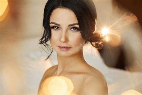 Beautiful And Naked Brunette Model Girl With Blue Eyes With Bright Makeup And With The Body