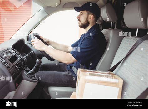 Delivery Man Driving His Van Stock Photo Alamy