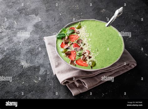 Smoothie bowl with fruits, berry, chocolate and sesame seeds on dark ...