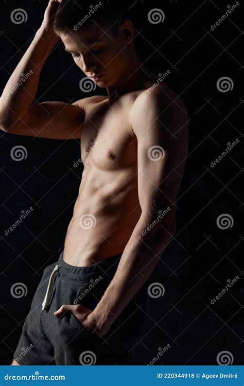 Guy With A Naked Torso Holds His Hand Near His Face On A Black Background Sports Fitness Stock