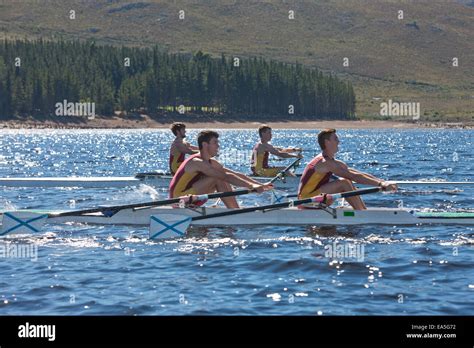 Two double scull rowing boats in water Stock Photo - Alamy