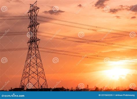 High Voltage Electric Pylon And Transmission Lines With Sunset Sky And