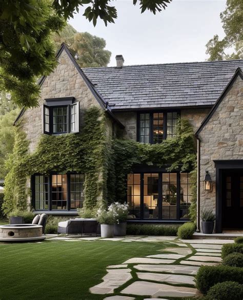 A Stone House With Ivy Growing On It S Walls And Windows In The Front Yard