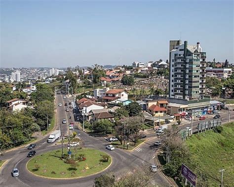 An Aerial View Of A City With Tall Buildings And Lots Of Cars On The Road