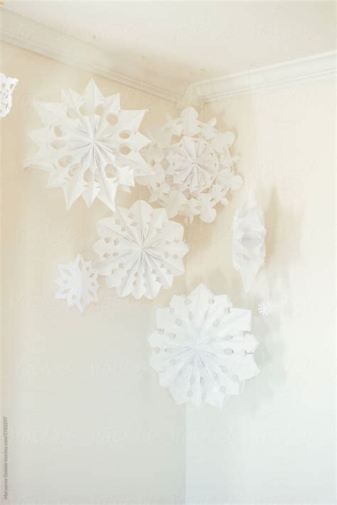 Paper Snowflakes Hanging From Living Room Ceiling By Stocksy