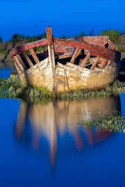 Premium Photo The Wreck Of An Old Wooden Fishing Boat Stranded On A