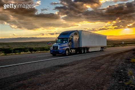 Long Haul Semi Truck Speeding Down A Four Lane Highway In A Beautiful