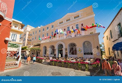 Tourists Walk Along Via Camerelle Near Grand Hotel Quisisana In Sunny