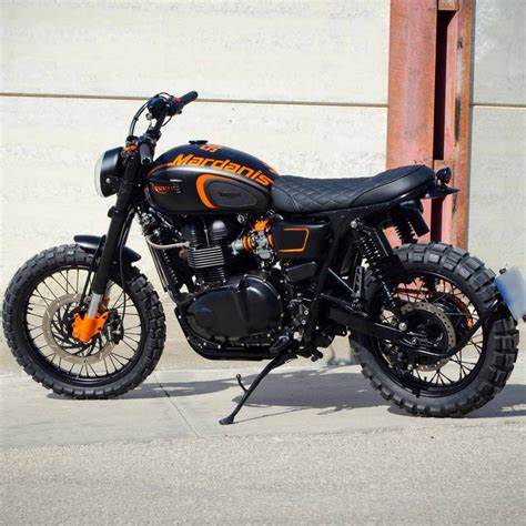 An Orange And Black Motorcycle Parked In Front Of A Building